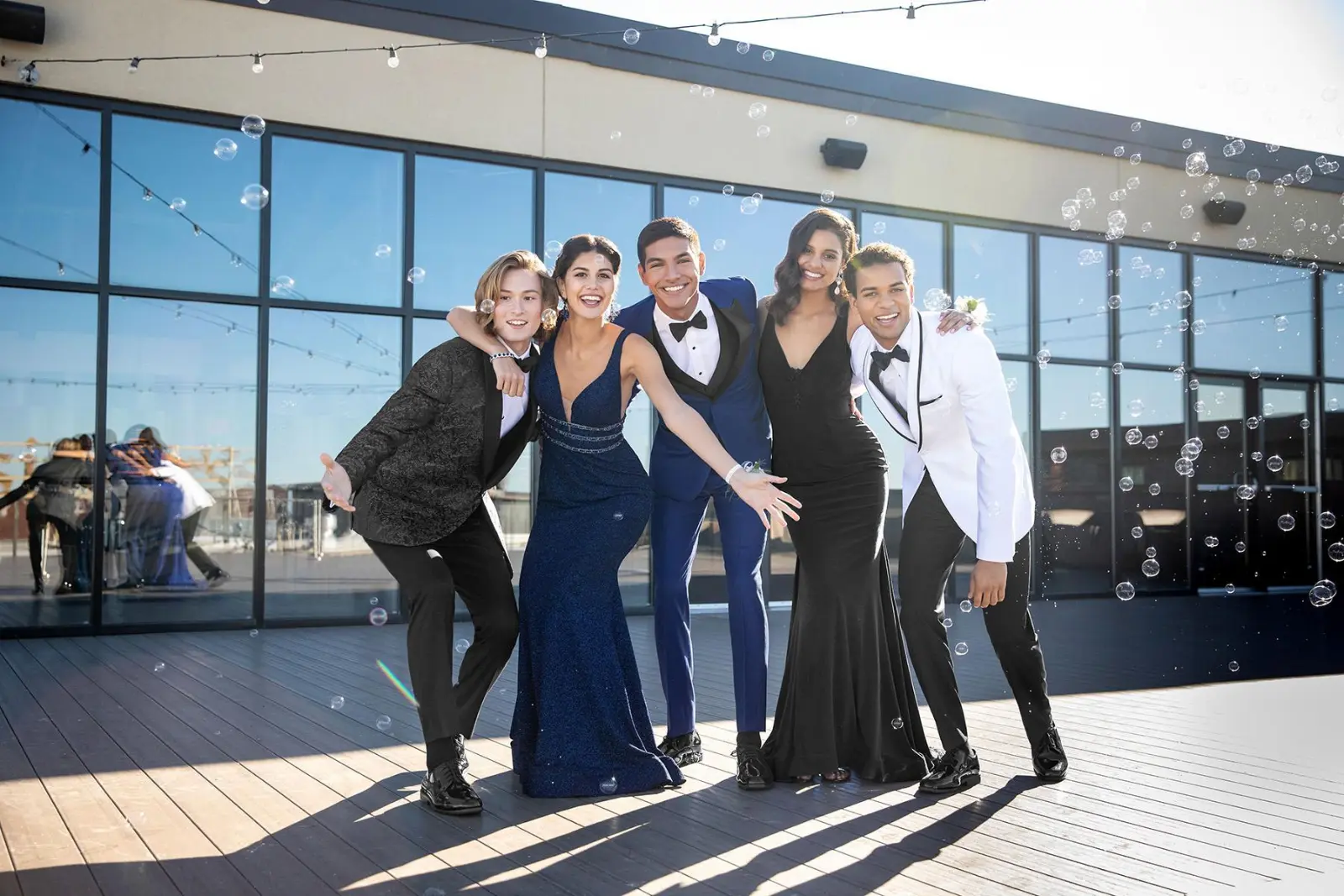 Prom Fashion Tuxedo Coats Group Group of high school students dressed for prom in tuxedos and gowns